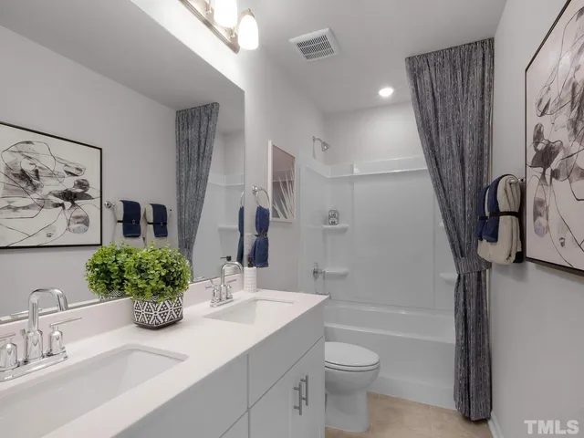 a bathroom with a granite countertop sink a toilet and shower