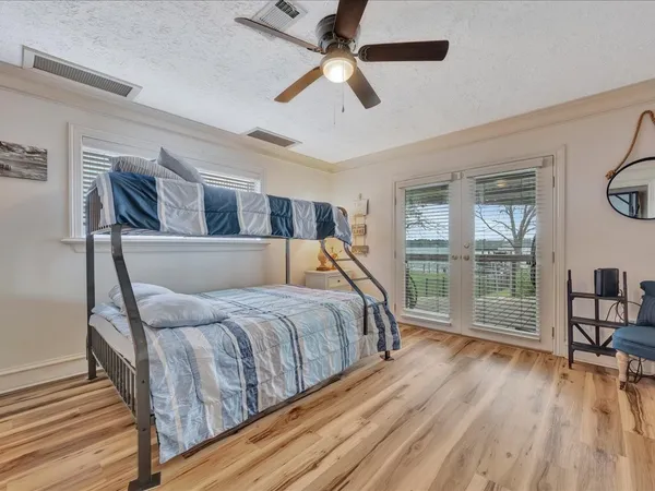 a bedroom with a bed and a large mirror