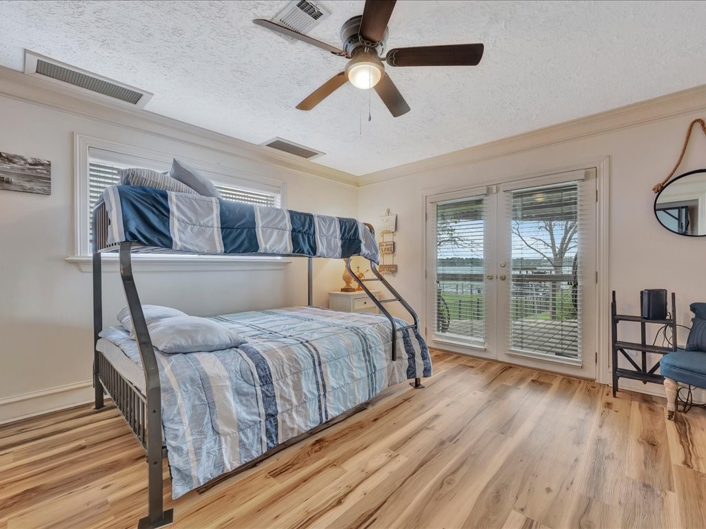 115 Harbor Add Drive Livingston, TX 77351 - Photo 13 of 44 a bed room with a bed and a book shelf