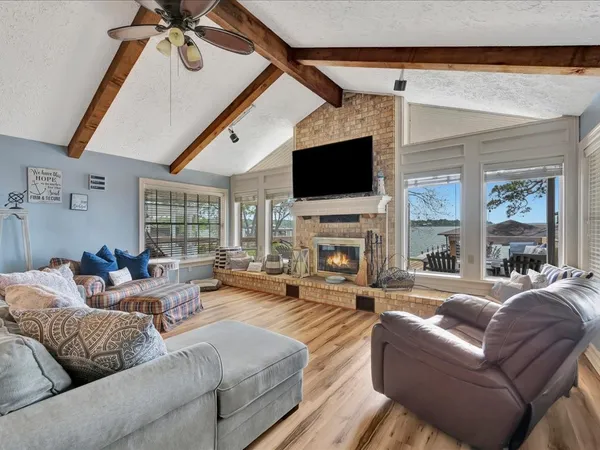 a living room with furniture a fireplace and a flat screen tv
