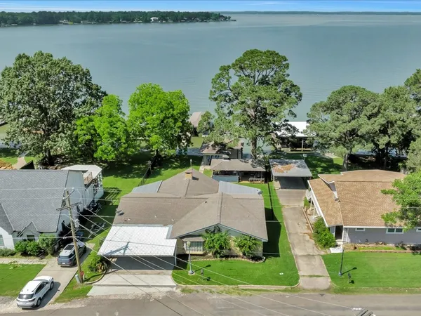 an aerial view of a house with outdoor space and street view