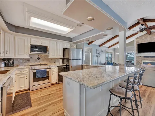 a kitchen with a stove a sink and a refrigerator