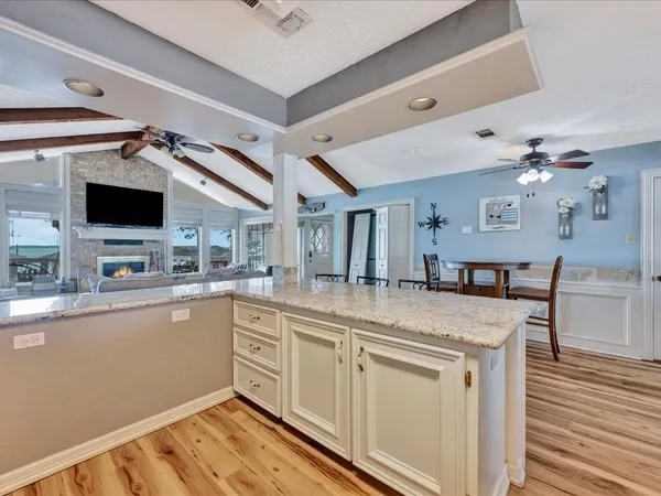 a kitchen with stainless steel appliances granite countertop a sink and dishwasher with wooden floor
