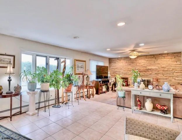 a living room with furniture and floor to ceiling windows