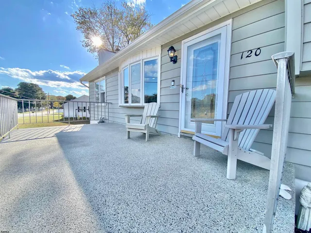 a living room with furniture kitchen view and a potted plant