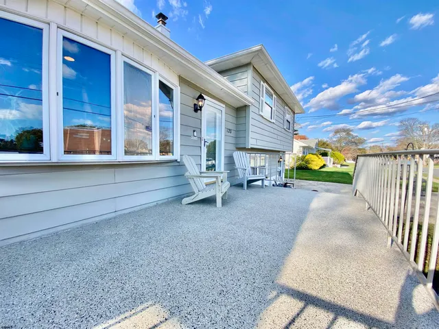 a living room with furniture and floor to ceiling windows