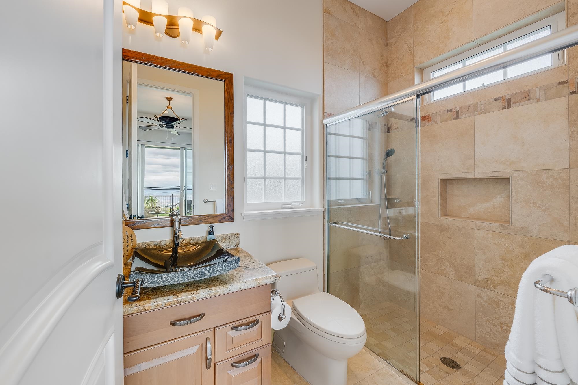 2705 Lower Kula Road Kula, HI 96790 - Photo 15 of 22 a bathroom with a granite countertop sink a toilet and shower