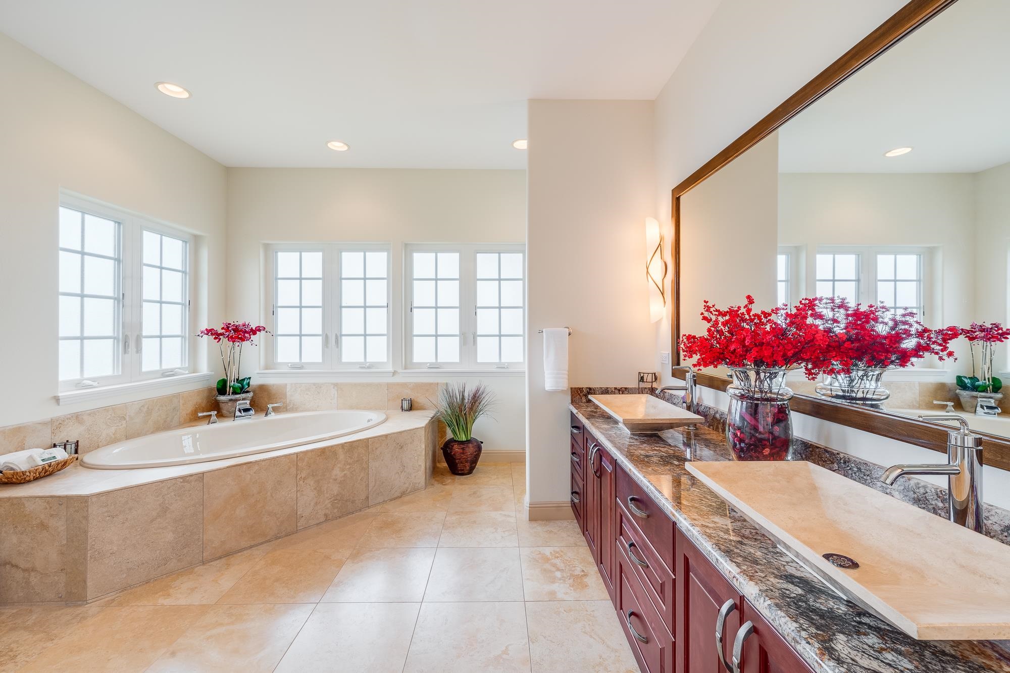 2705 Lower Kula Road Kula, HI 96790 - Photo 10 of 22 a spacious bathroom with granite countertop bathtub a sink and mirror