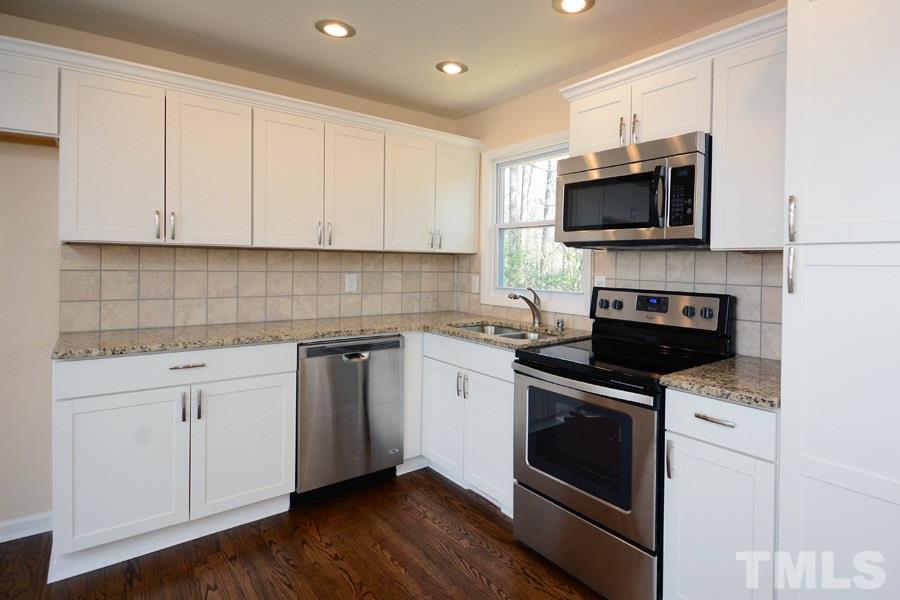 1717 Euclid Road Durham, NC 27713 - Photo 3 of 16 a kitchen with white cabinets stainless steel appliances and sink