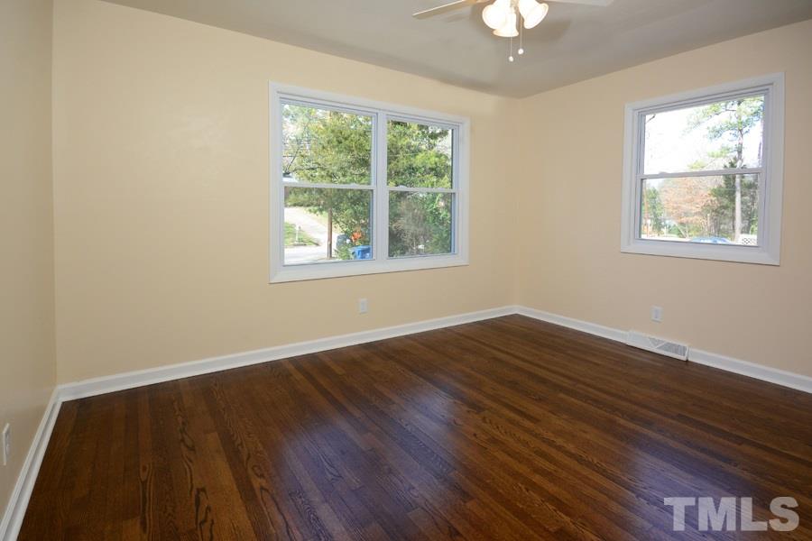 1717 Euclid Road Durham, NC 27713 - Photo 6 of 16 a view of an empty room with wooden floor and a window