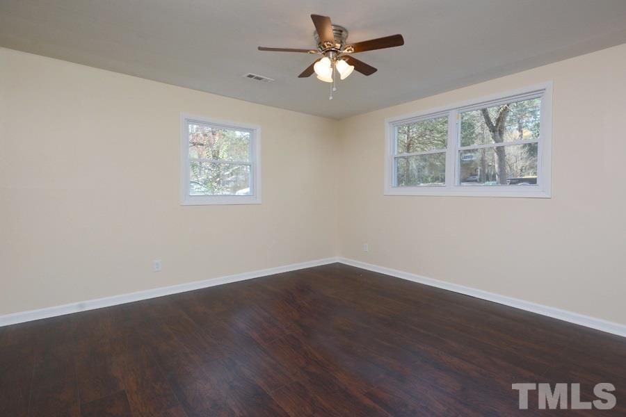 1717 Euclid Road Durham, NC 27713 - Photo 7 of 16 a view of an empty room with wooden floor and a window