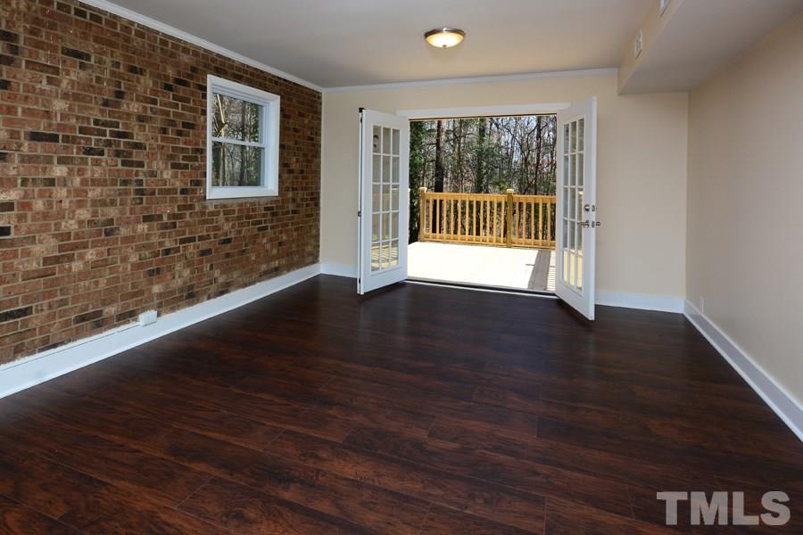 1717 Euclid Road Durham, NC 27713 - Photo 10 of 16 a view of an empty room with wooden floor and a window