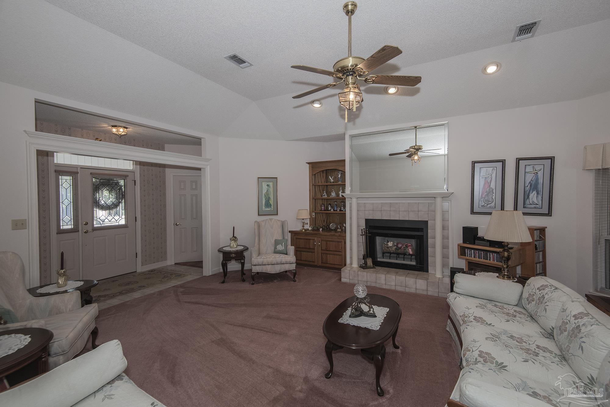 1505 Kings Road Cantonment, FL 32533 - Photo 11 of 57 a living room with furniture and a fireplace