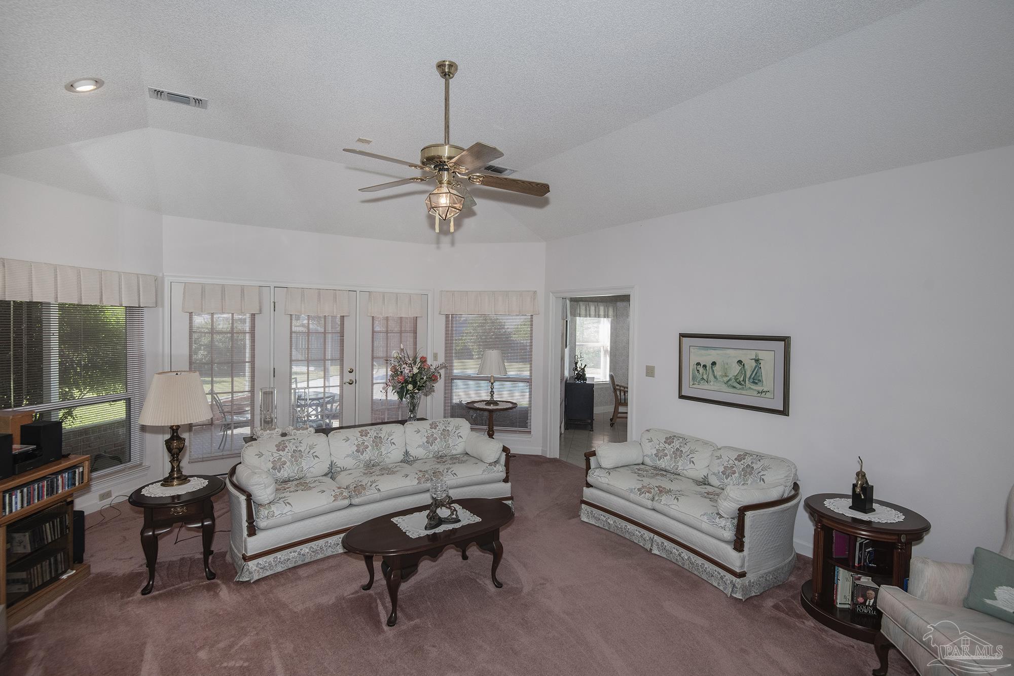 1505 Kings Road Cantonment, FL 32533 - Photo 12 of 57 a living room with furniture and a chandelier