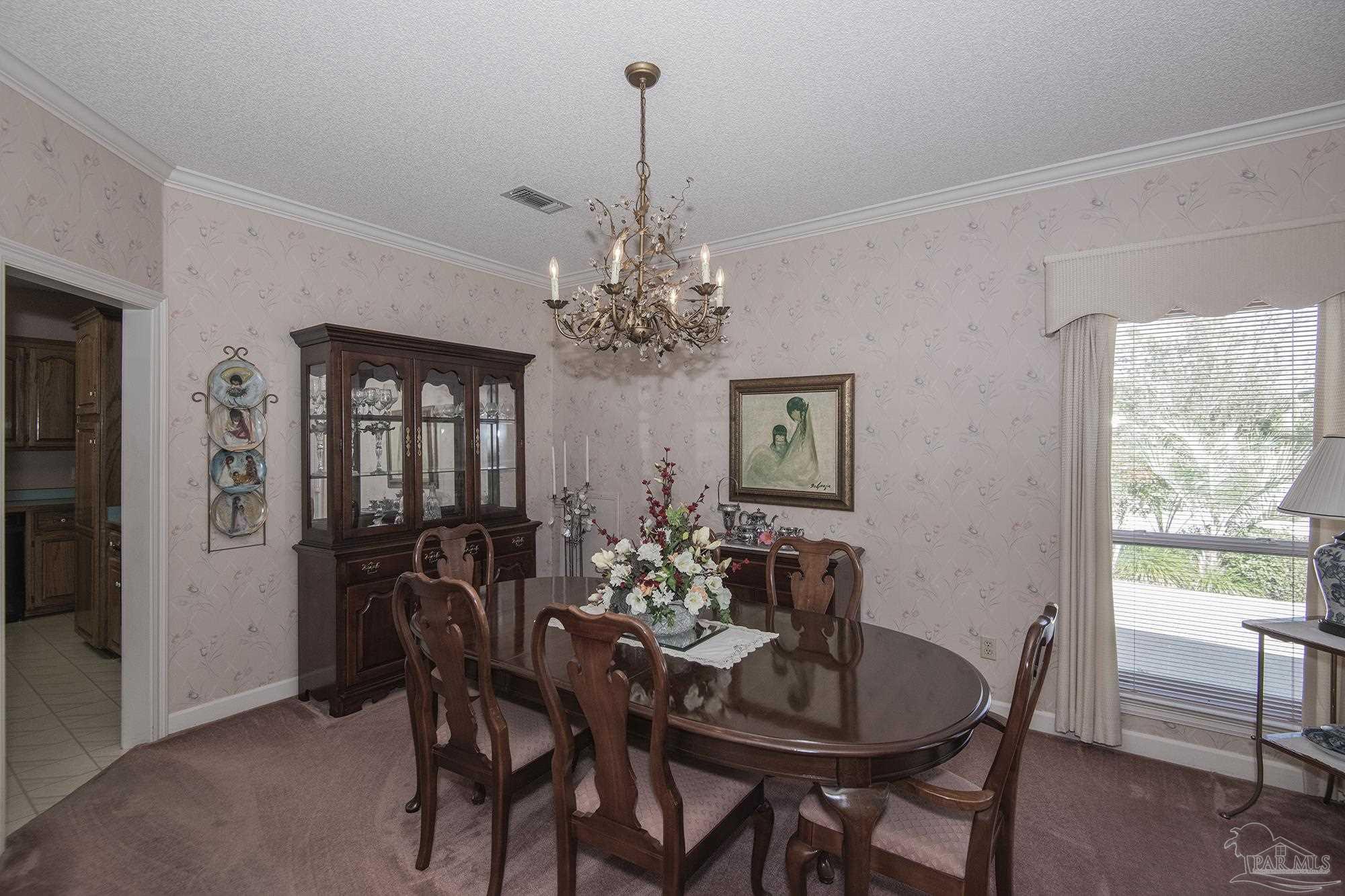 1505 Kings Road Cantonment, FL 32533 - Photo 13 of 57 a view of a dining room with furniture and window