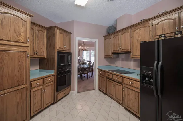a kitchen with stainless steel appliances a refrigerator and a sink