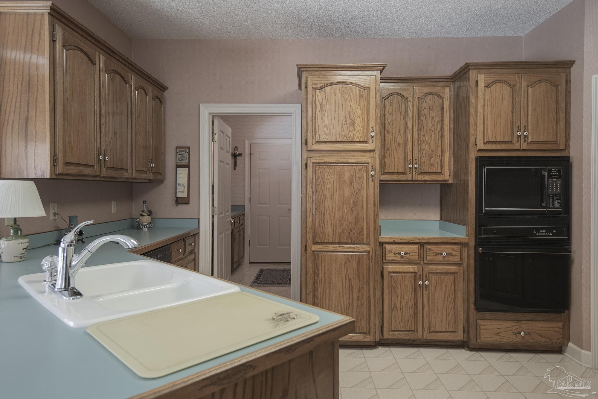 1505 Kings Road Cantonment, FL 32533 - Photo 17 of 57 a kitchen with stainless steel appliances a refrigerator and a sink