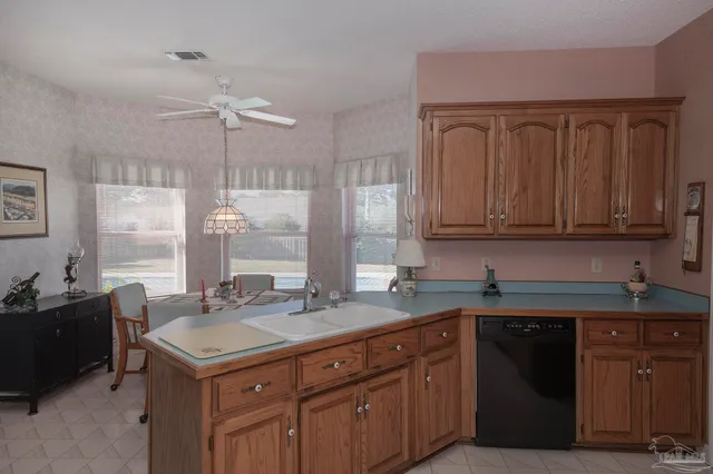a kitchen with stainless steel appliances granite countertop a refrigerator a stove and a sink
