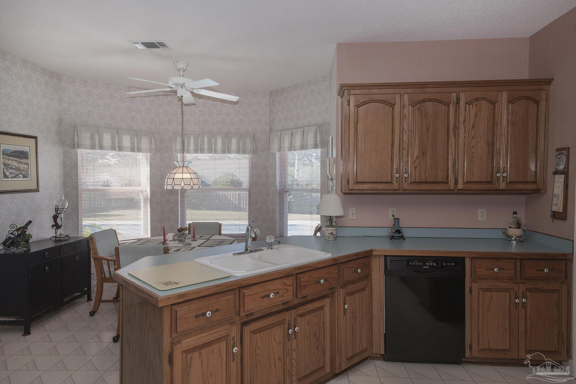 1505 Kings Road Cantonment, FL 32533 - Photo 18 of 57 a kitchen with a sink and cabinets