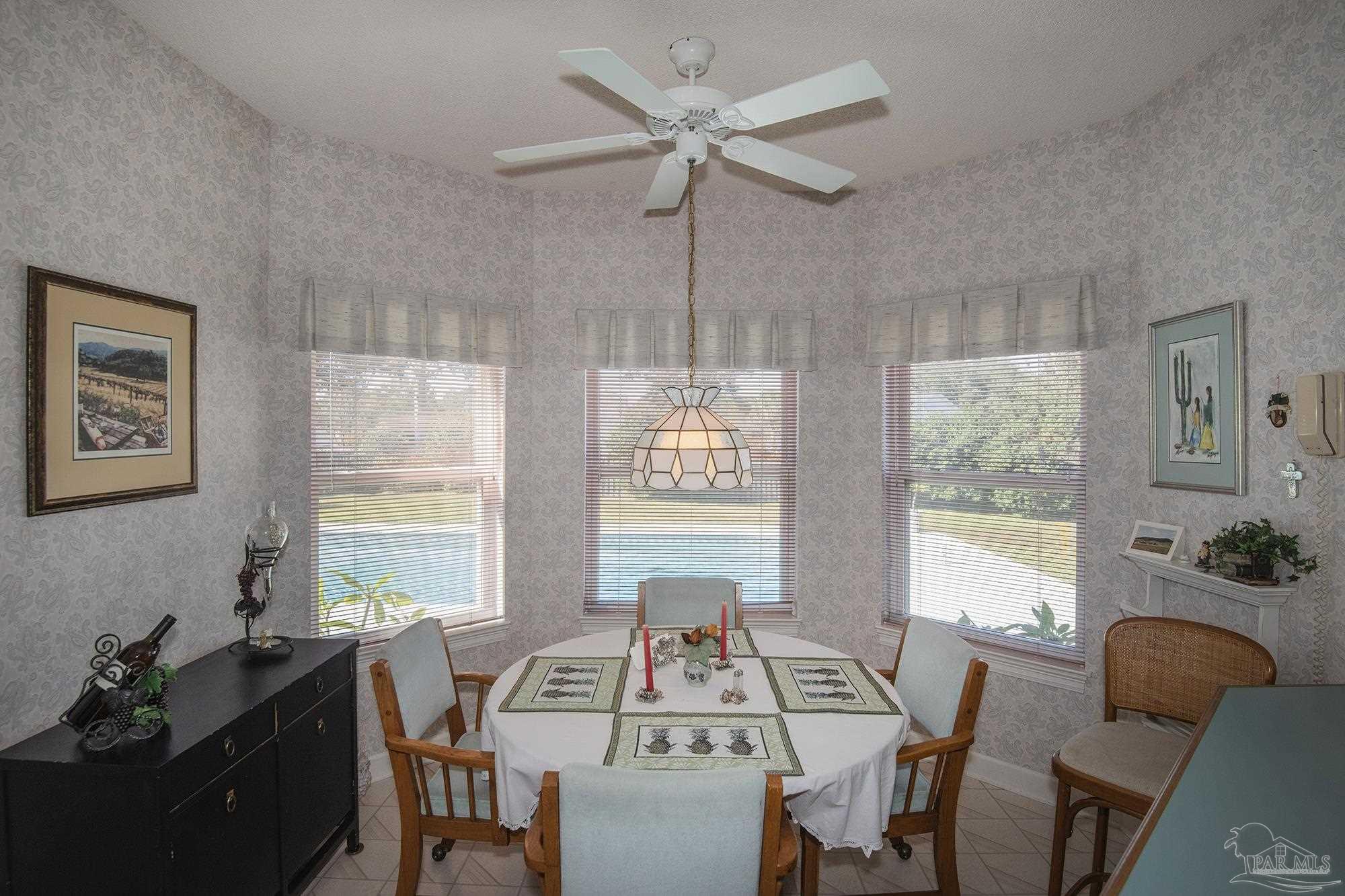 1505 Kings Road Cantonment, FL 32533 - Photo 23 of 57 a view of a dining room with furniture window and outside view