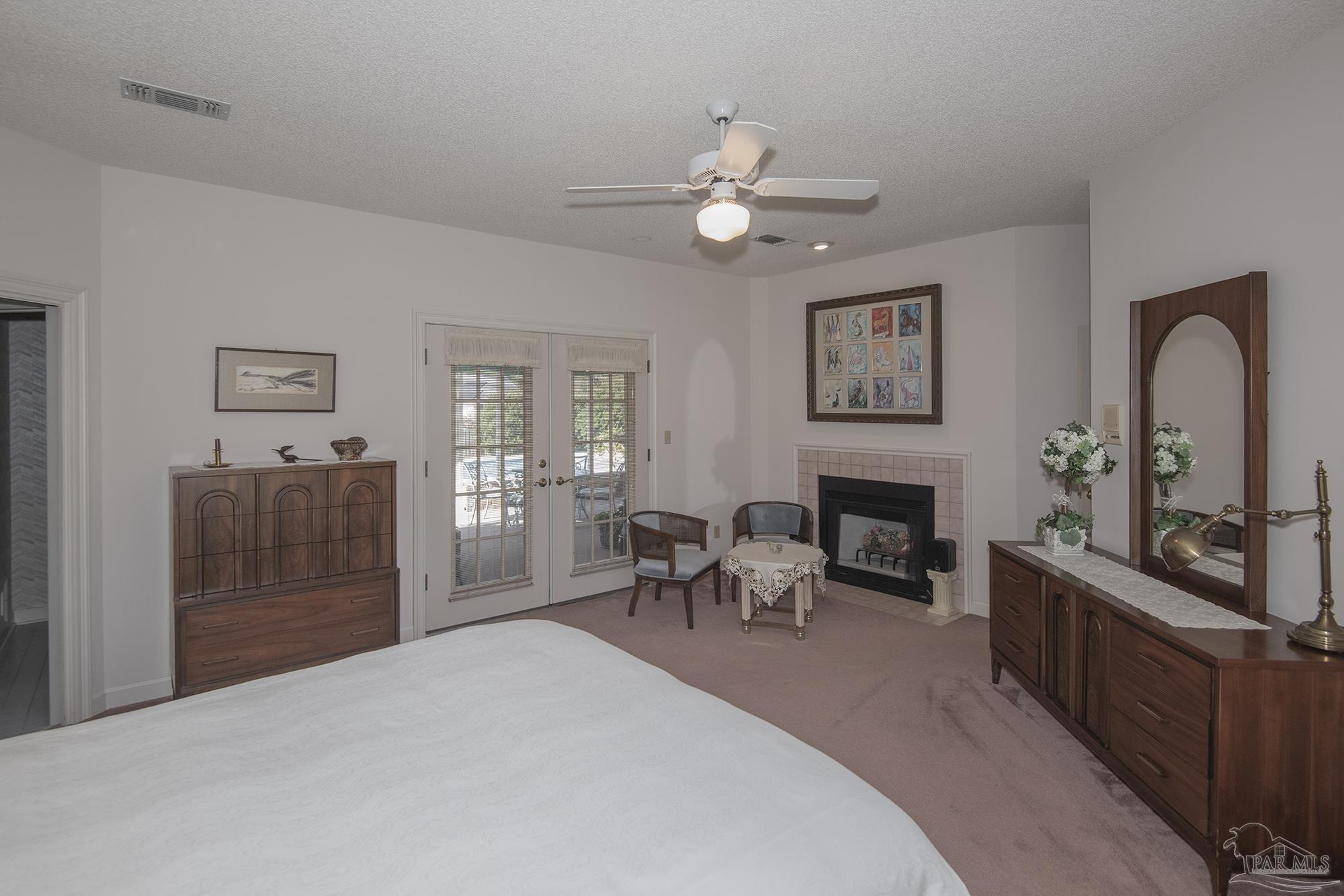 1505 Kings Road Cantonment, FL 32533 - Photo 24 of 57 a living room with furniture a fireplace and a flat screen tv