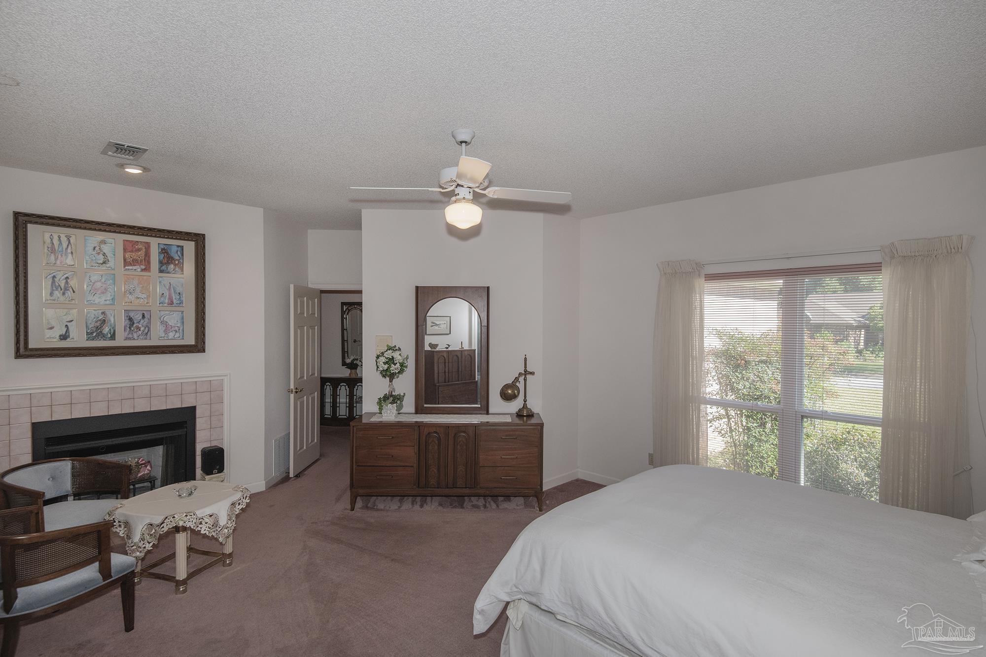 1505 Kings Road Cantonment, FL 32533 - Photo 26 of 57 a bedroom with a bed and a chandelier