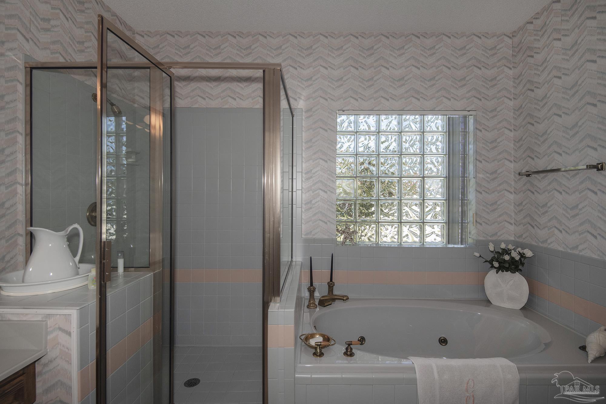 1505 Kings Road Cantonment, FL 32533 - Photo 29 of 57 a bathroom with a tub shower vanity and a sink