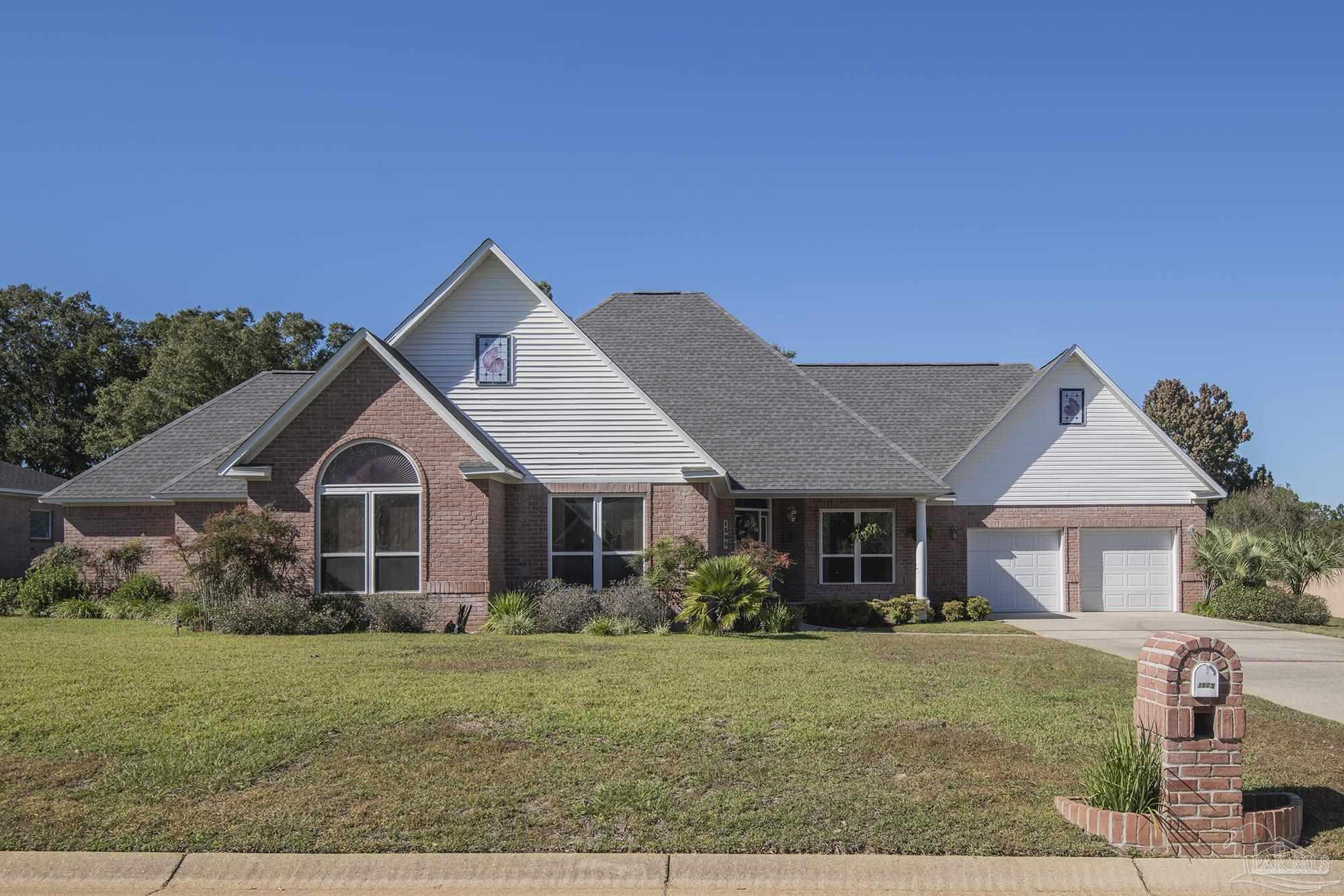 1505 Kings Road Cantonment, FL 32533 - Photo 3 of 57 a front view of a house with garden