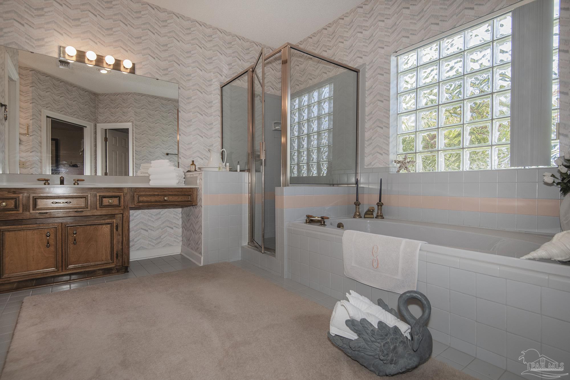 1505 Kings Road Cantonment, FL 32533 - Photo 31 of 57 a bathroom with a tub sink and mirror