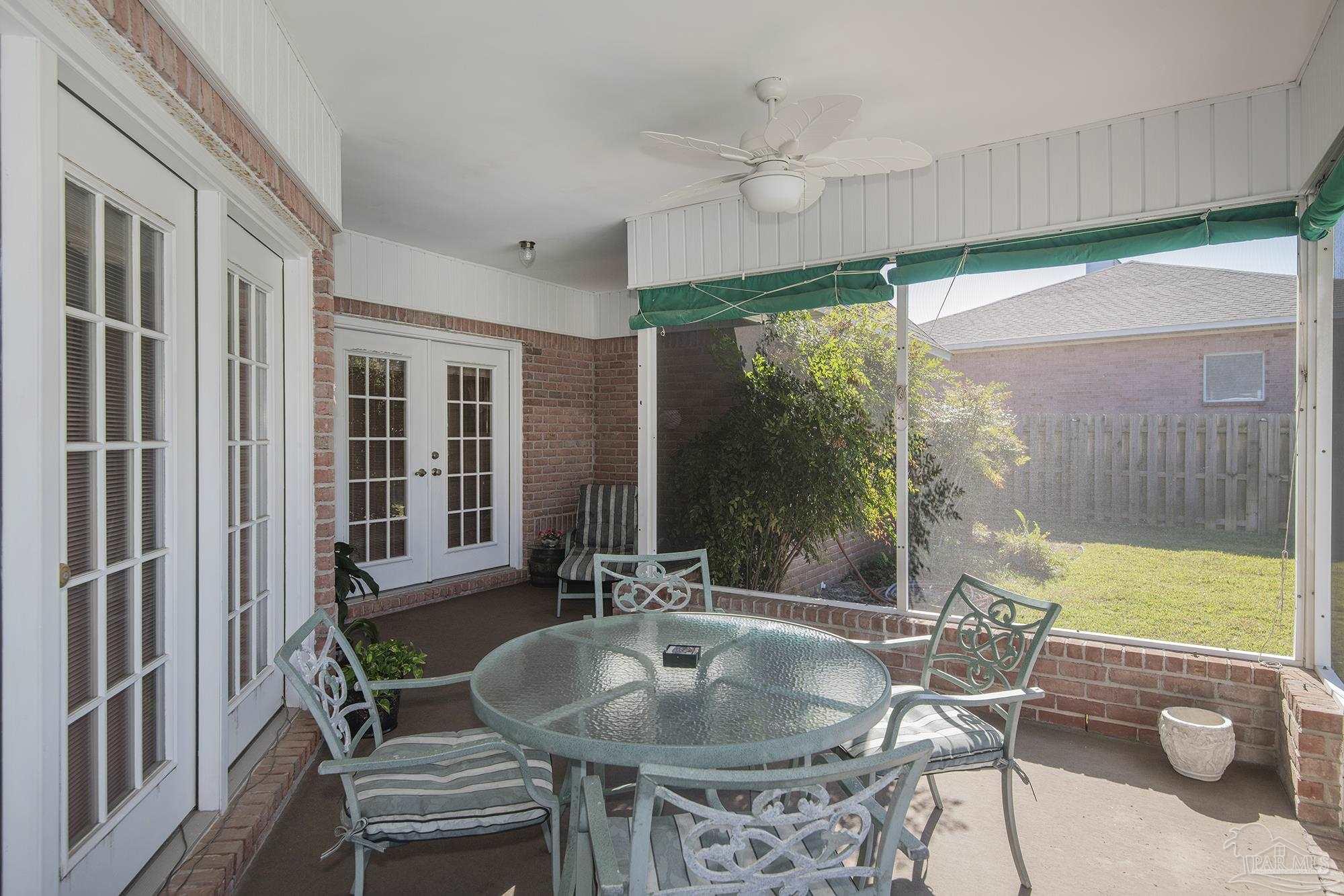 1505 Kings Road Cantonment, FL 32533 - Photo 34 of 57 a dining room with furniture and a floor to ceiling window