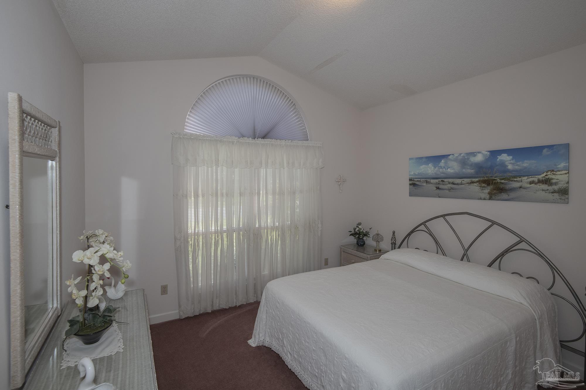 1505 Kings Road Cantonment, FL 32533 - Photo 36 of 57 a bedroom with a bed and a chandelier