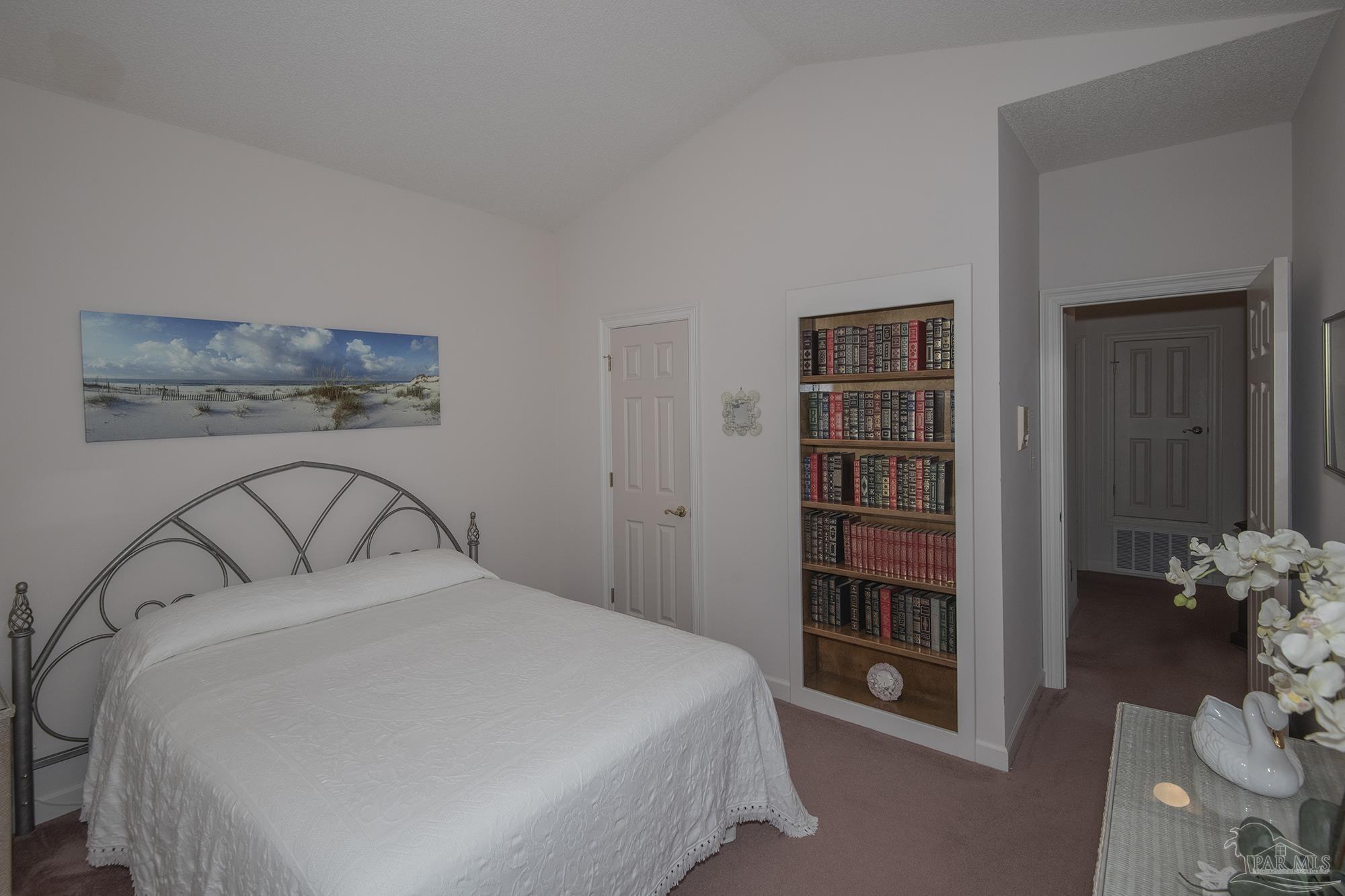 1505 Kings Road Cantonment, FL 32533 - Photo 37 of 57 a bedroom with a bed a dresser and book shelf