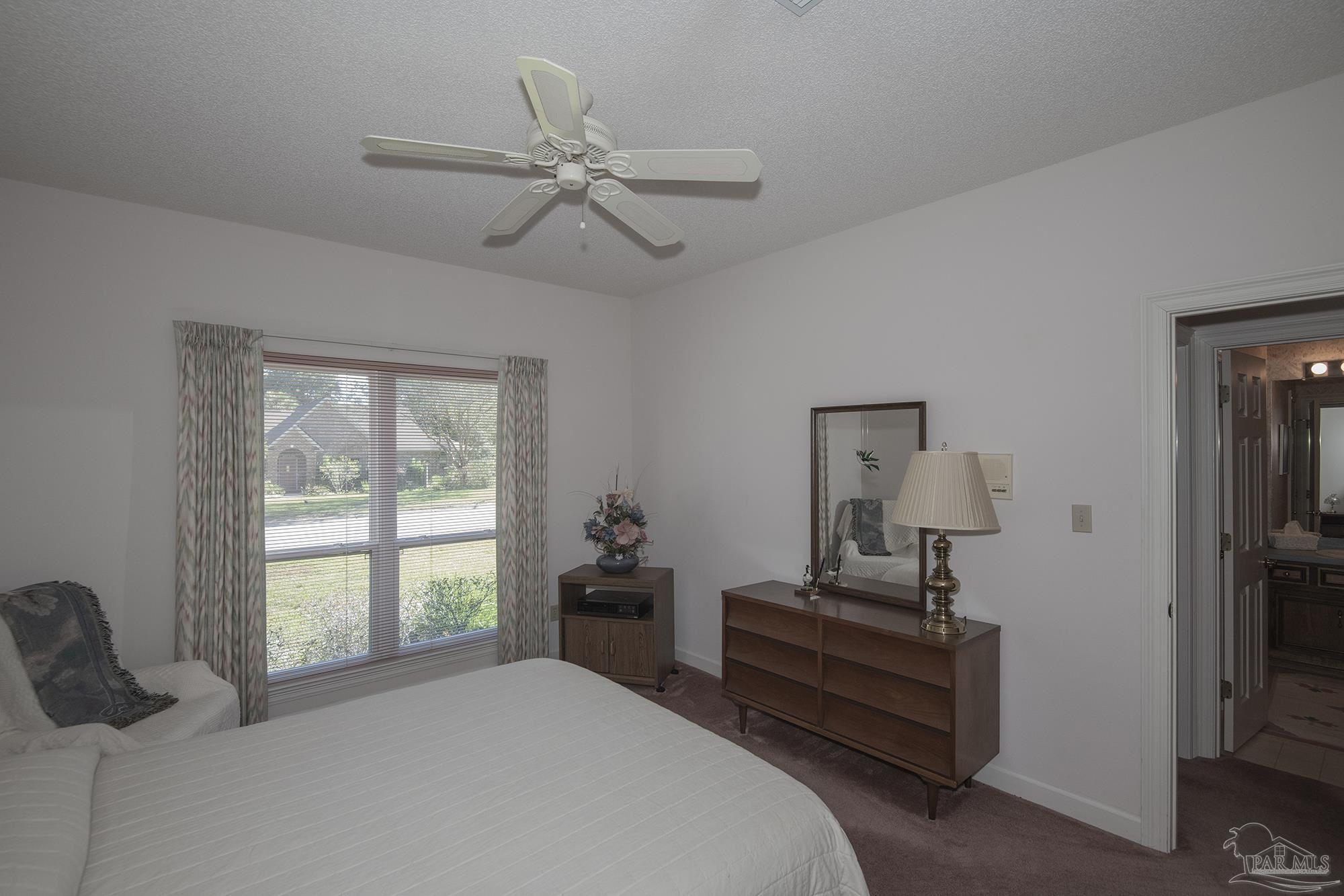 1505 Kings Road Cantonment, FL 32533 - Photo 39 of 57 a bedroom with a bed and wooden floor