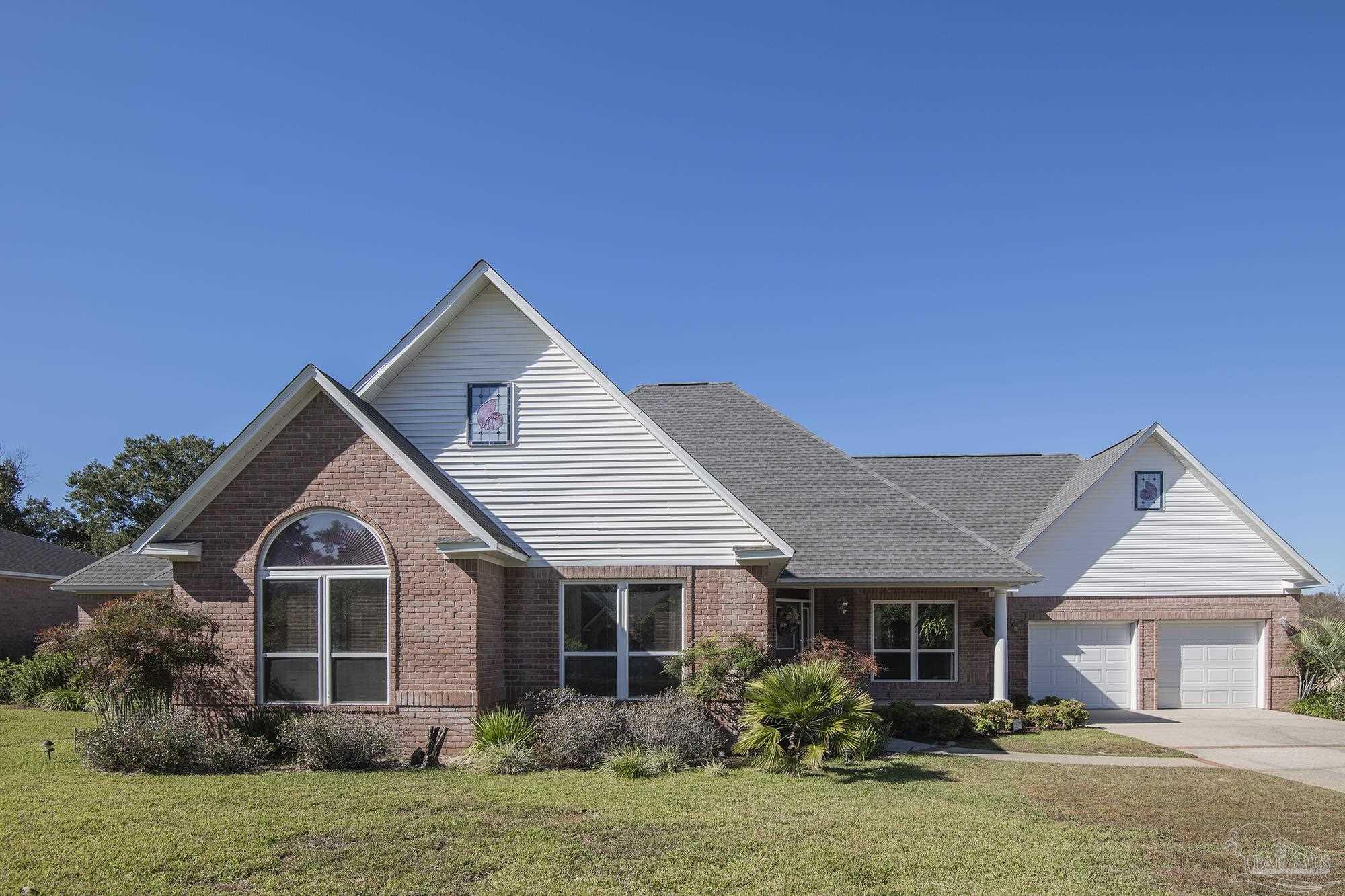 1505 Kings Road Cantonment, FL 32533 - Photo 4 of 57 a front view of a house with a yard
