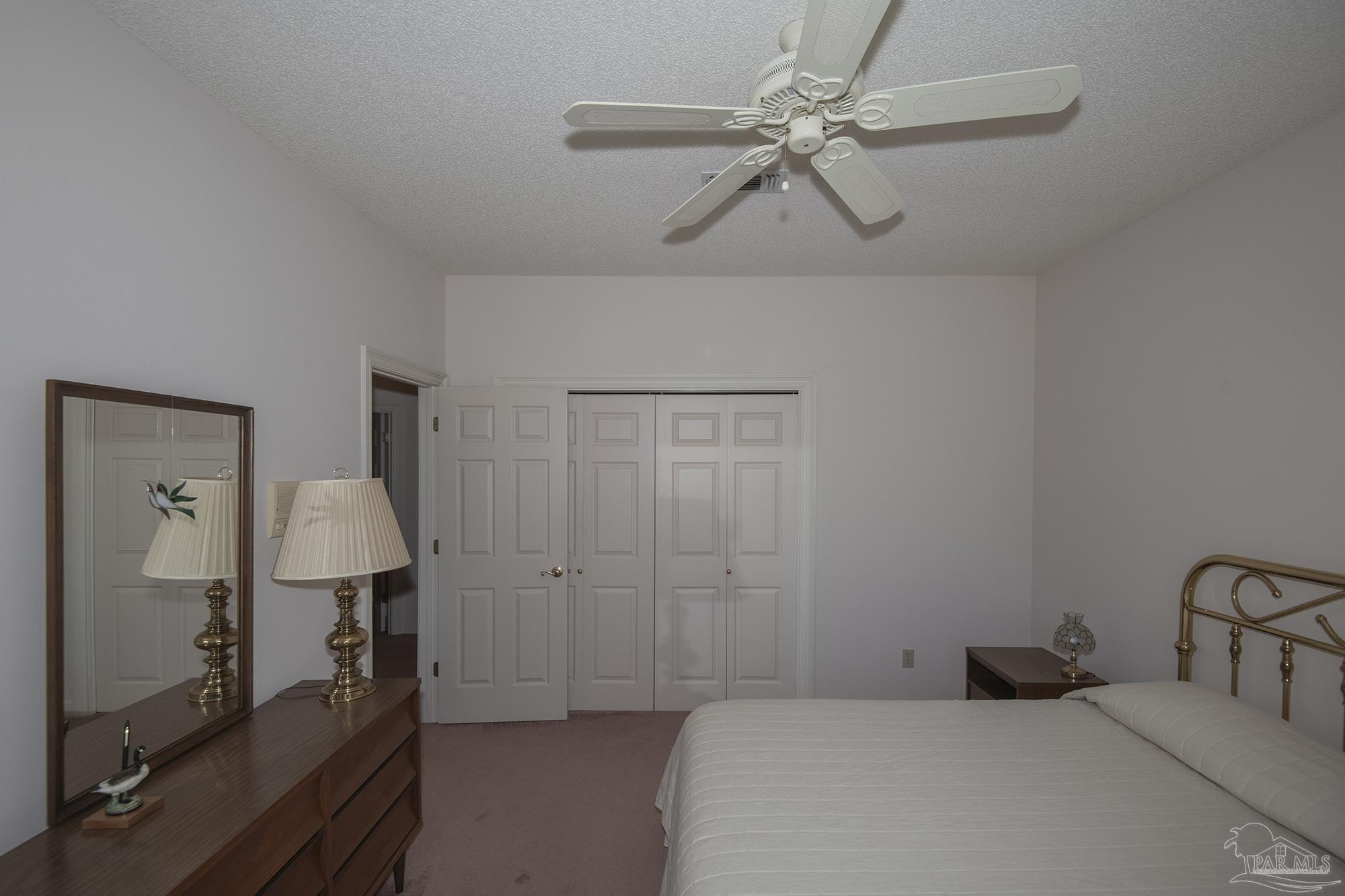 1505 Kings Road Cantonment, FL 32533 - Photo 41 of 57 a bedroom with a bed and a chandelier