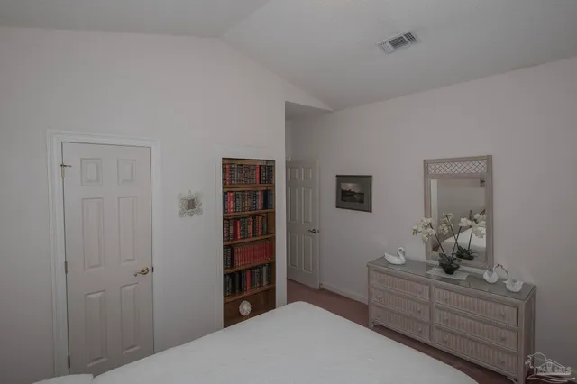 a view of a hallway with entryway and stairs