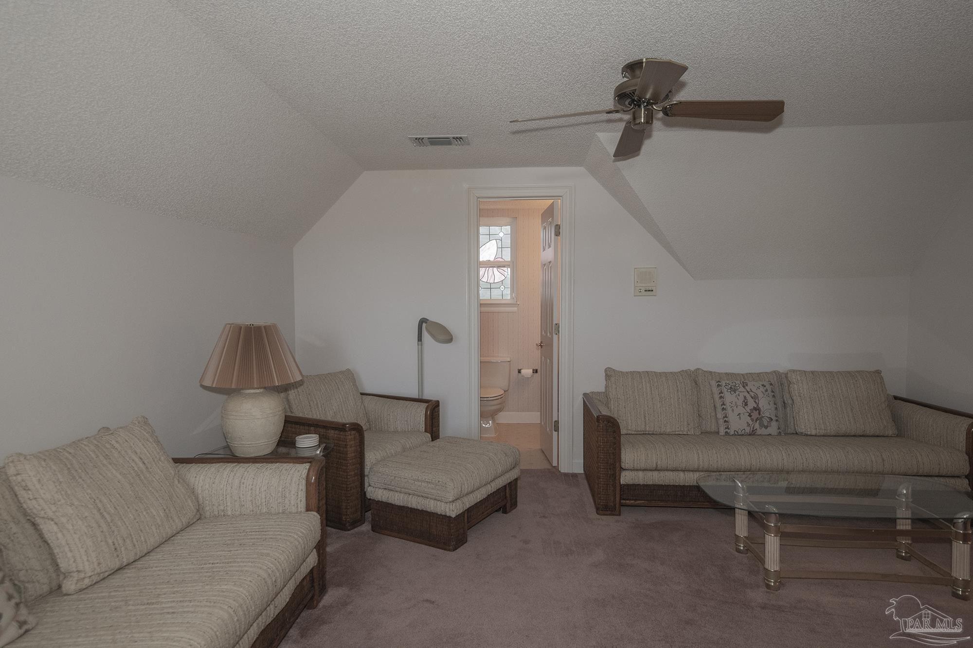 1505 Kings Road Cantonment, FL 32533 - Photo 46 of 57 a living room with furniture and a potted plant on table