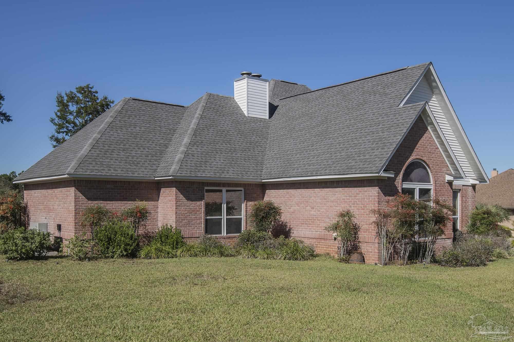1505 Kings Road Cantonment, FL 32533 - Photo 5 of 57 a front view of a house with a yard