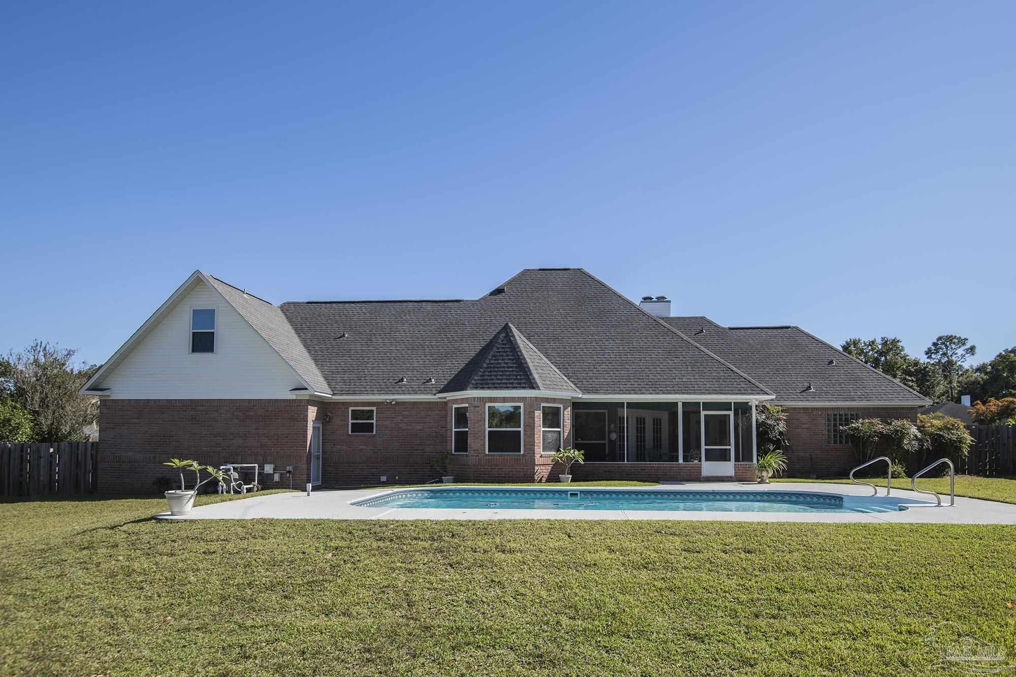 1505 Kings Road Cantonment, FL 32533 - Photo 52 of 57 a front view of a house with a yard