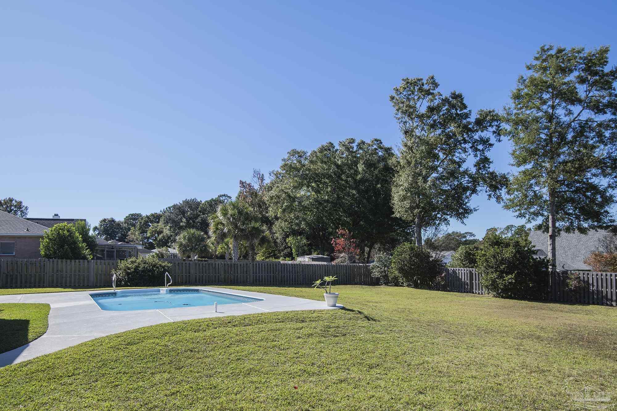 1505 Kings Road Cantonment, FL 32533 - Photo 53 of 57 a view of a swimming pool with an outdoor space and seating area