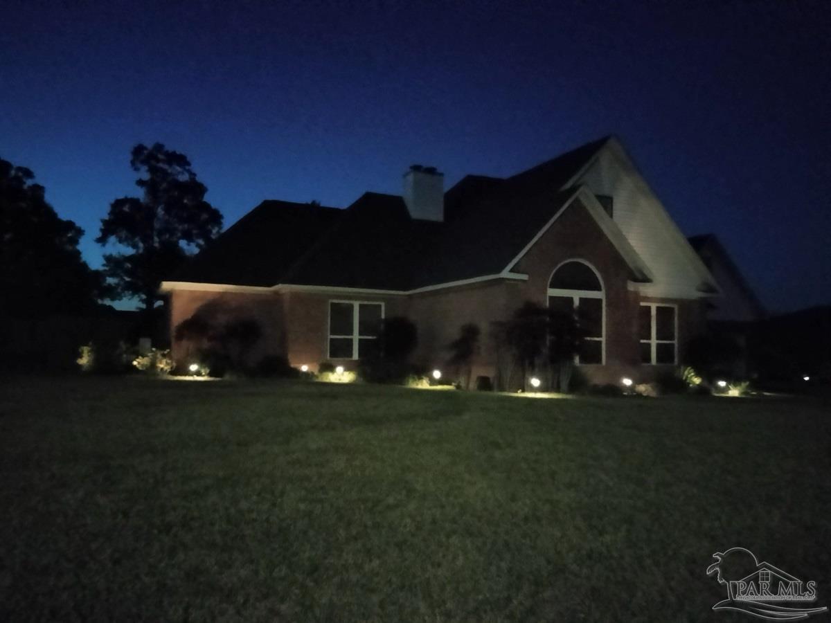 1505 Kings Road Cantonment, FL 32533 - Photo 56 of 57 a front view of a house with a yard