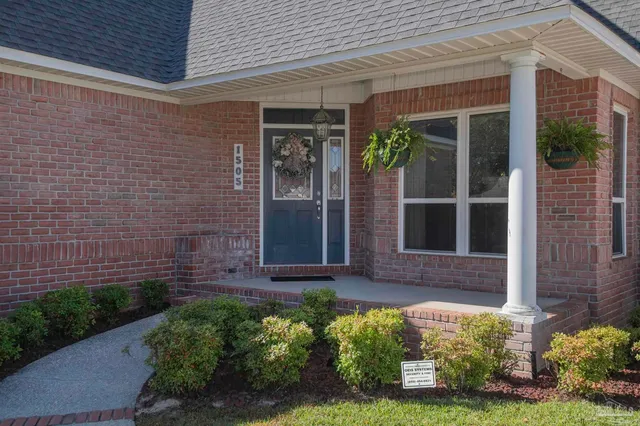 front view of a brick house with a large window