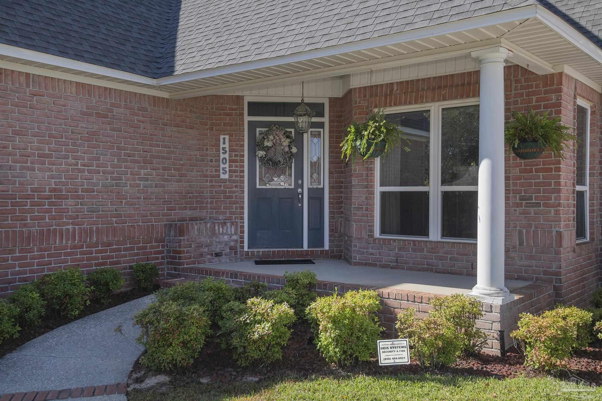 1505 Kings Road Cantonment, FL 32533 - Photo 6 of 57 front view of a brick house with a large window
