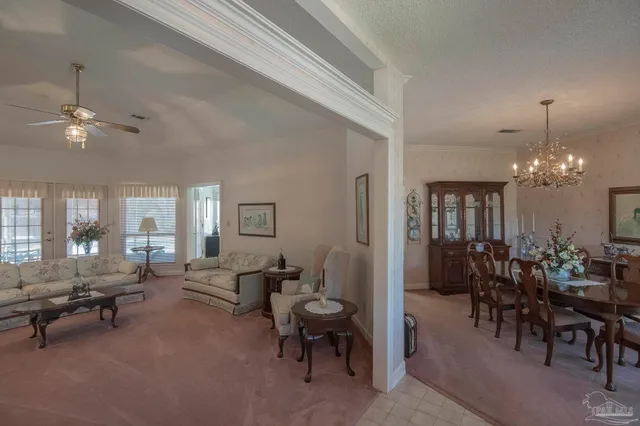 a living room with furniture and a chandelier