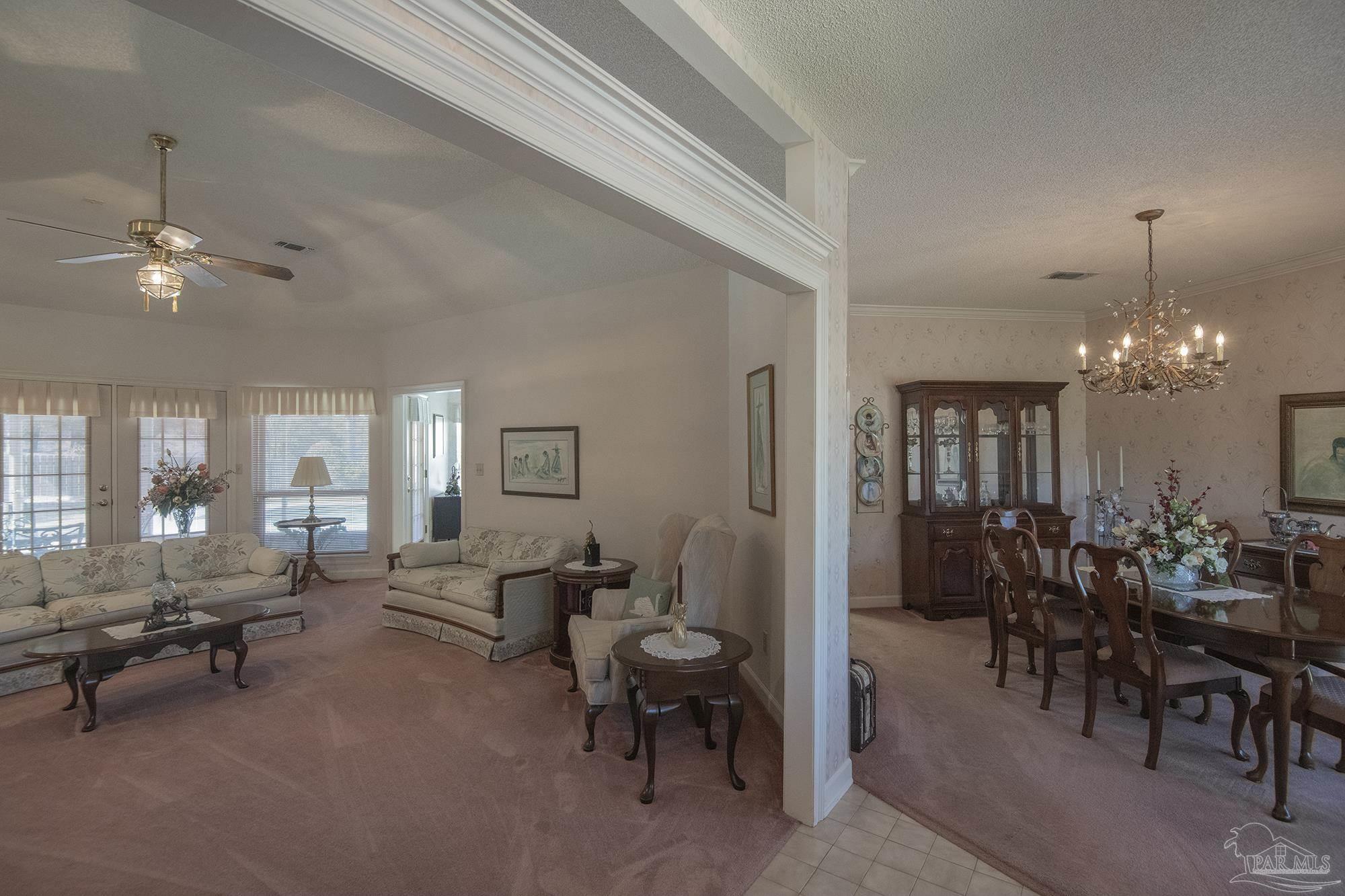 1505 Kings Road Cantonment, FL 32533 - Photo 7 of 57 a living room with furniture and a chandelier
