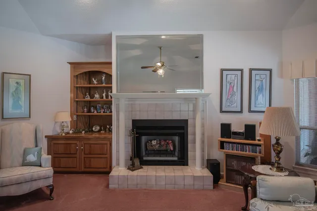 a living room with furniture a fireplace and a flat screen tv