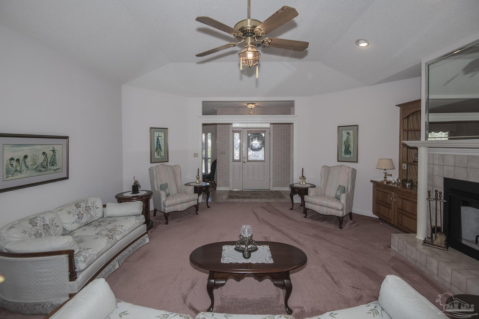 1505 Kings Road Cantonment, FL 32533 - Photo 10 of 57 a living room with furniture a fireplace and a flat screen tv