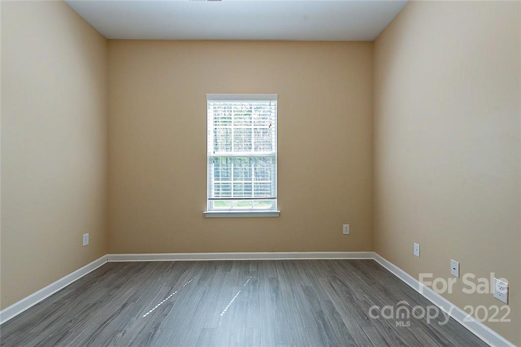 1629 Beleek Ridge Lane Clover, SC 29710 - Photo 12 of 23 a view of an empty room with wooden floor and a window