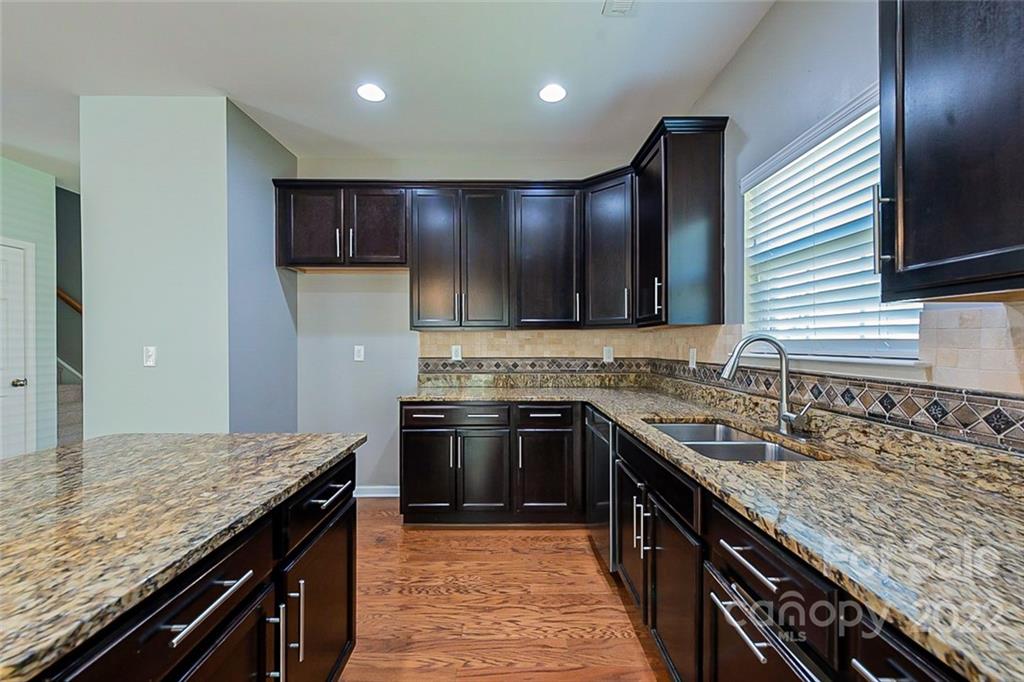 1629 Beleek Ridge Lane Clover, SC 29710 - Photo 8 of 23 a kitchen with stainless steel appliances granite countertop granite counter tops a sink and a refrigerator