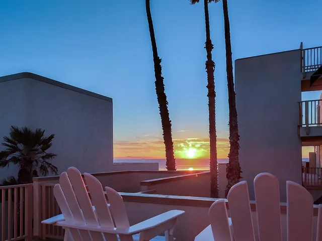 a view of balcony with two chairs and a potted plant